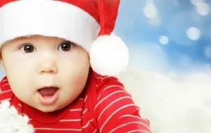 Surprised baby in Santa hat having fun, Christmas and Happy New