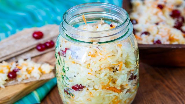 sauerkraut in a white plate on a wooden background