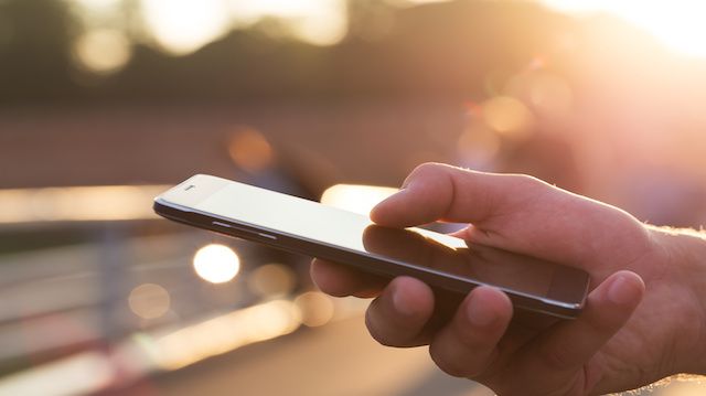 Man using his Mobile Phone outdoor