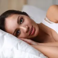 Pretty woman lying  in bed