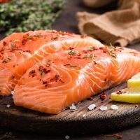 Fresh salmon fish fillet on wooden board