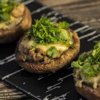 Stuffed mushrooms on a rough wooden surface