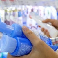 Close Up Of Female Hands With Cosmetic Goods In Skin Care Shop